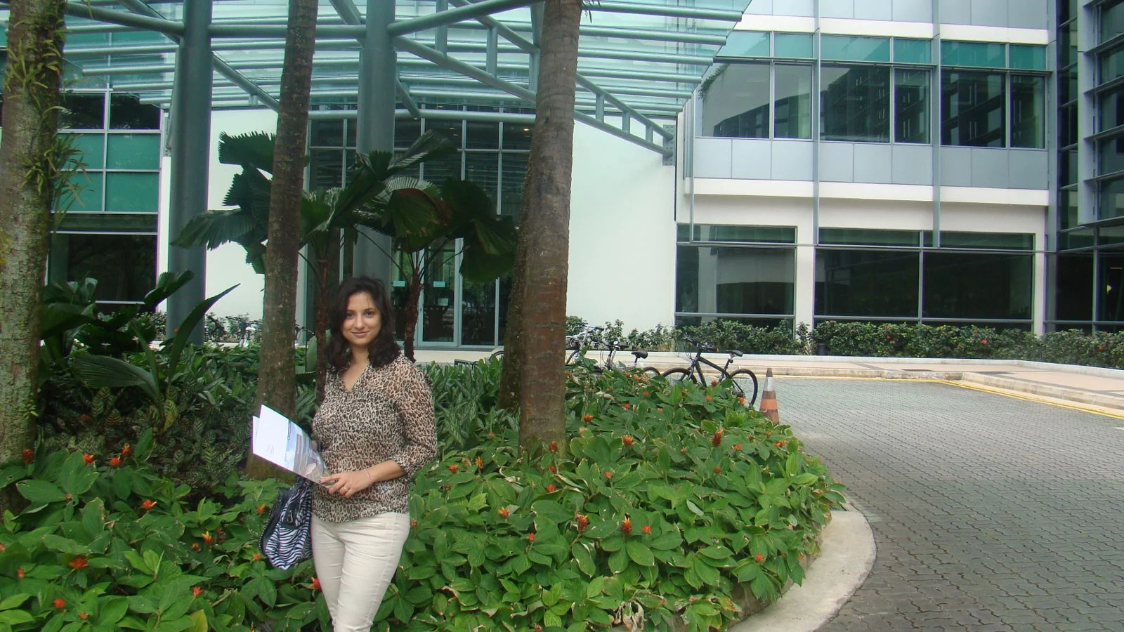 Nidhi Raina standing outside a modern office building