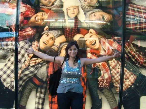 Nidhi Raina standing joyfully with her arms open